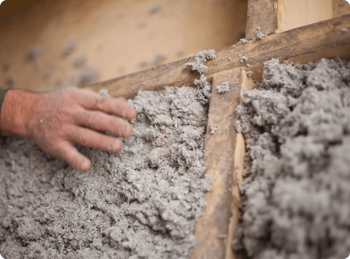 Worker applying insulation for energy efficiency